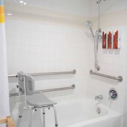 Chair and hand rails in ADA accessible bath tub