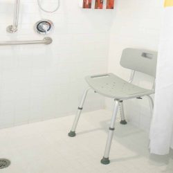 Chair and wall handle rails in ADA accessible walk in shower