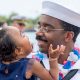 Navy father holding his daughter sweetly looking into each other's eyes