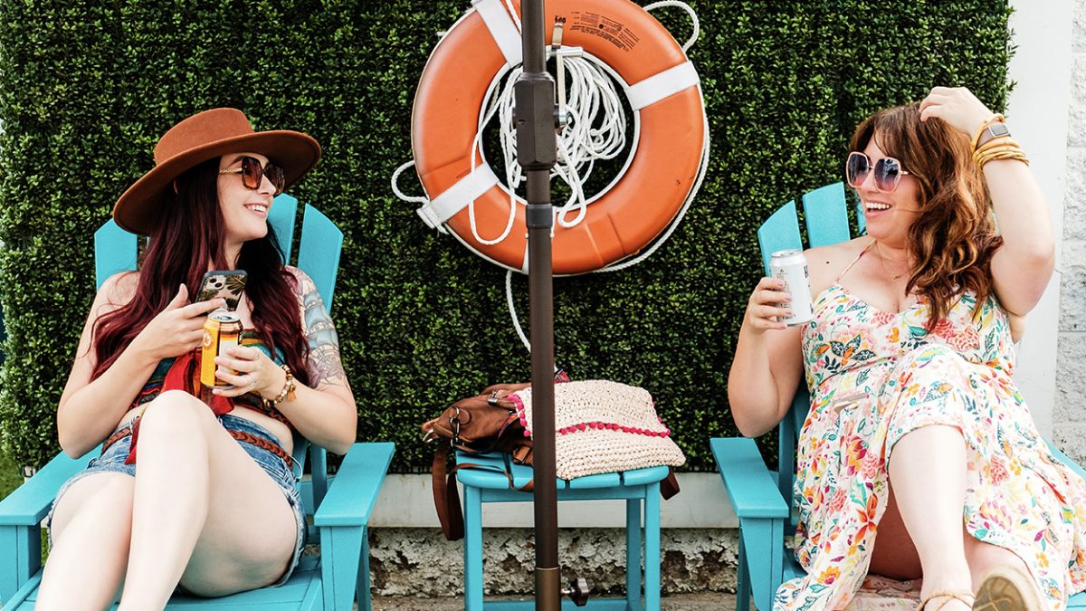 Two girls lounging in a pool area