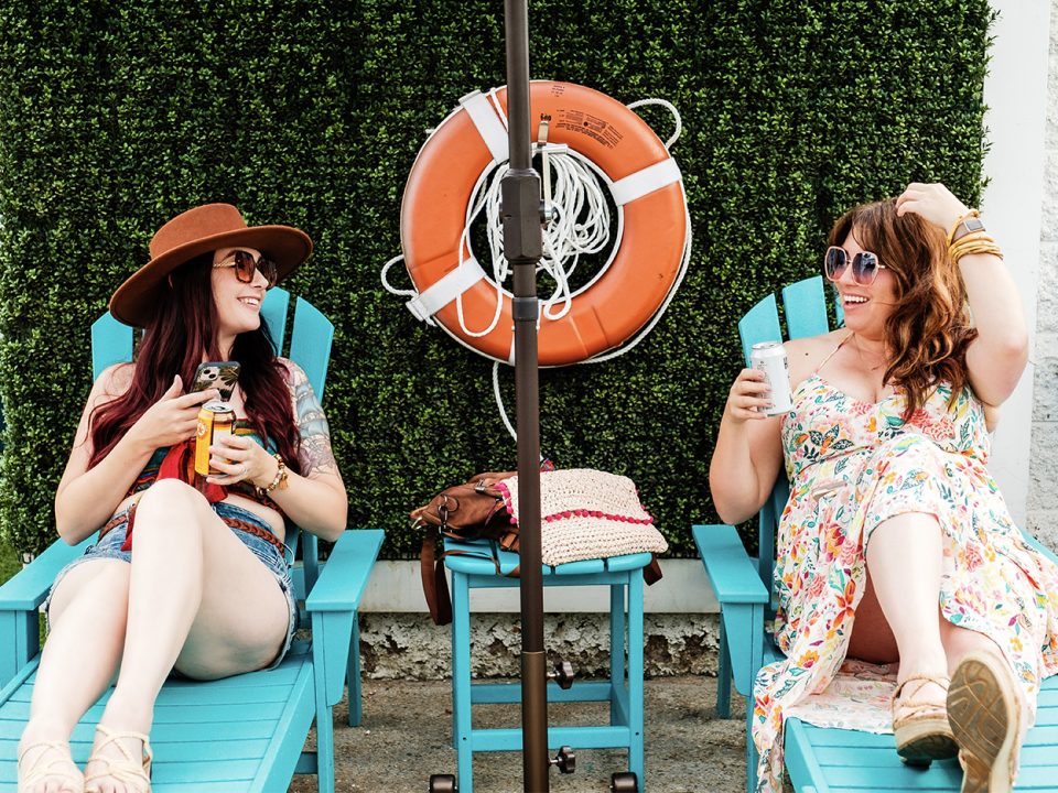 Two girls lounging in a pool area