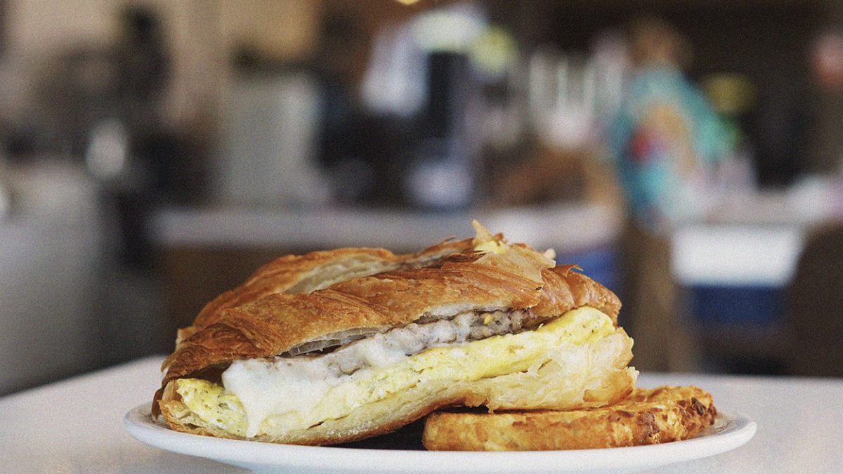 Croissant breakfast sandwich with sausage and egg