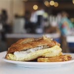 Croissant breakfast sandwich with sausage and egg