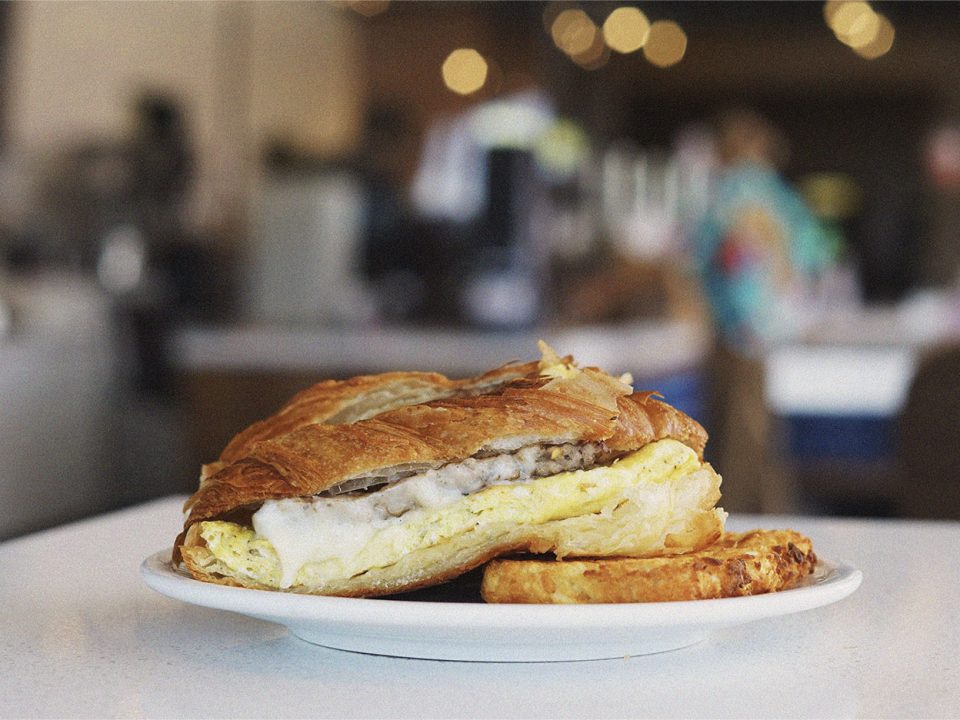 Croissant breakfast sandwich with sausage and egg